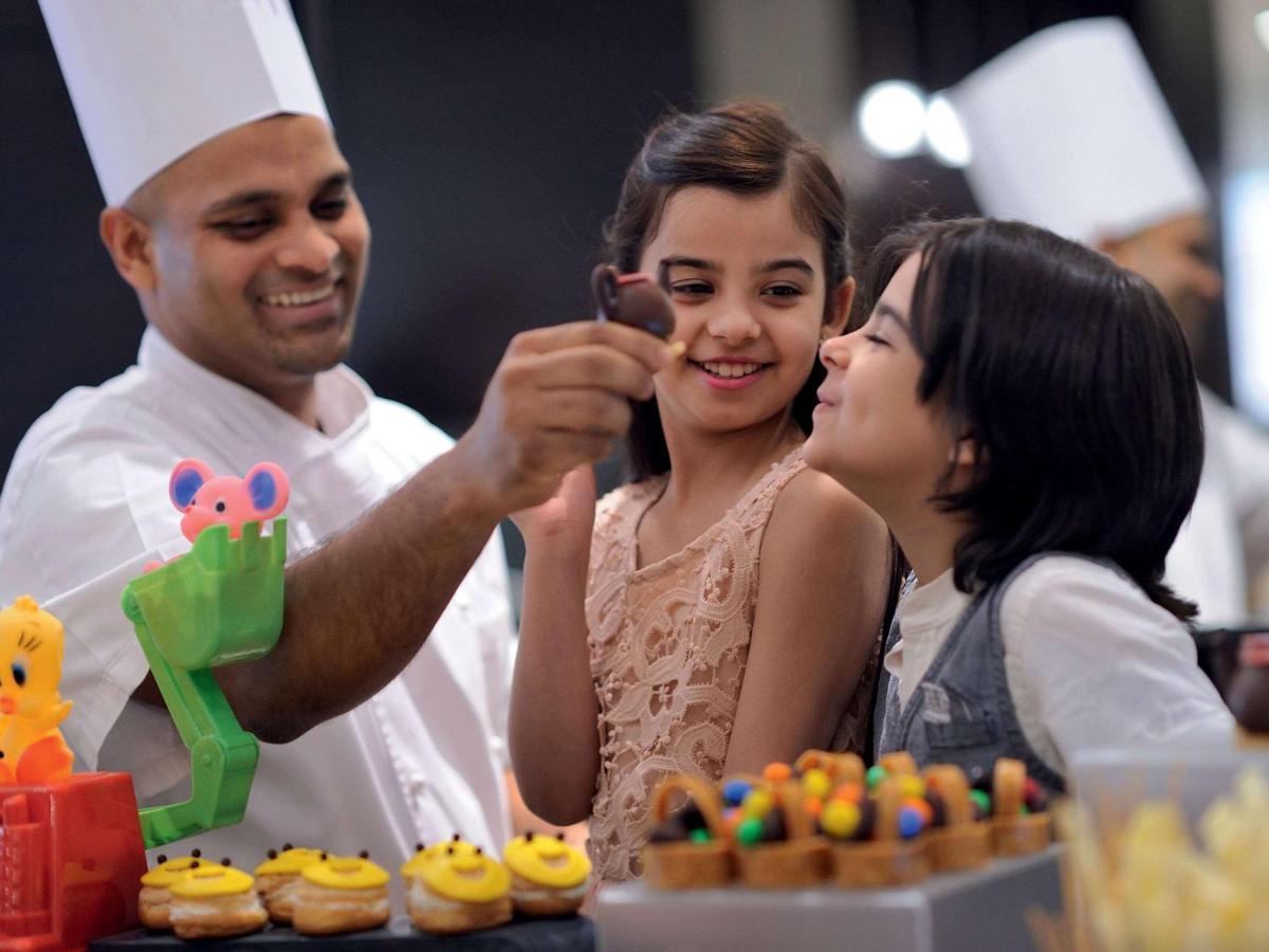 Movenpick Jumeirah Village Triangle Dubai Exteriör bild A pastry chef at work
